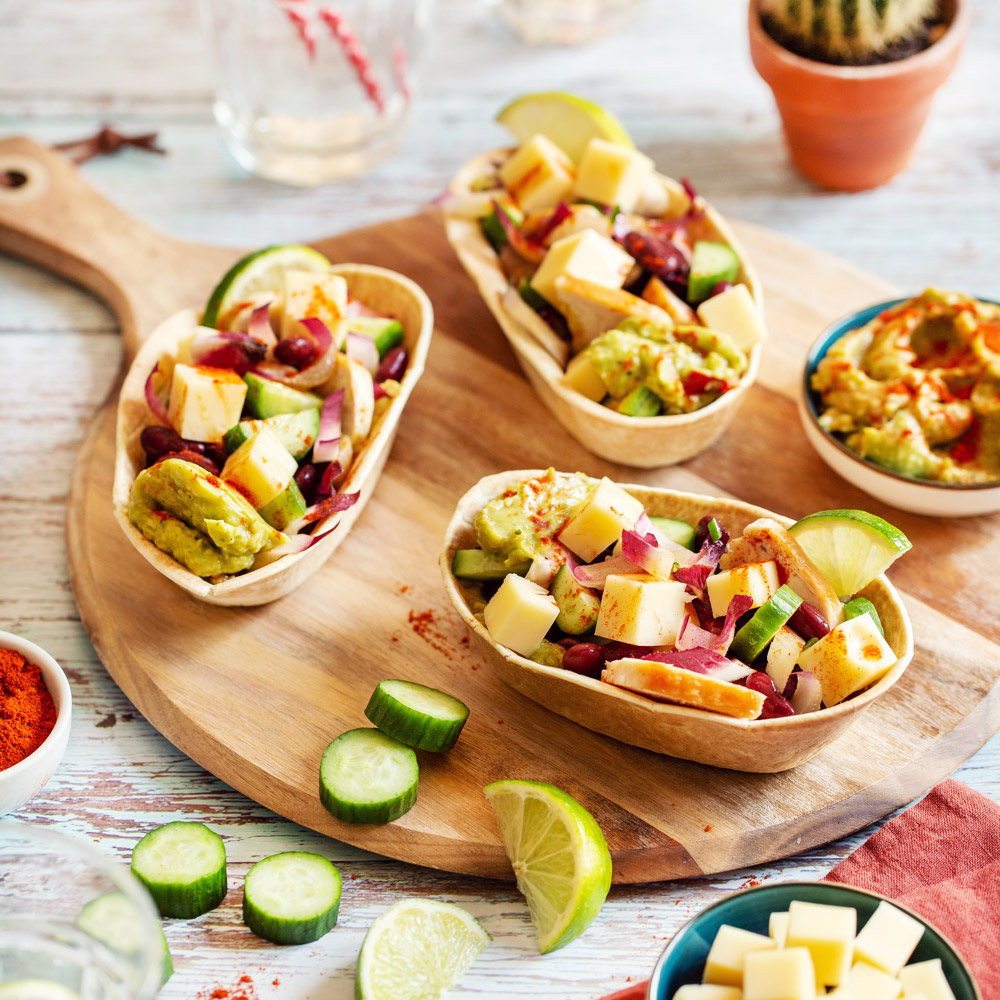 Tacos with diced Emmental, minced chicken and guacamole